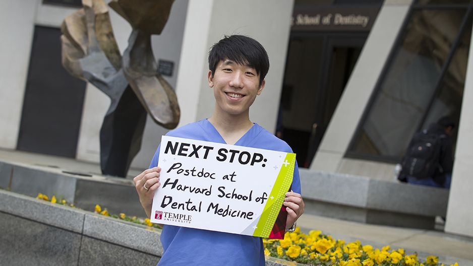 Andy Lee holding a sign that says "Next stop: postdoc at Harvard School of Dental Medicine." 