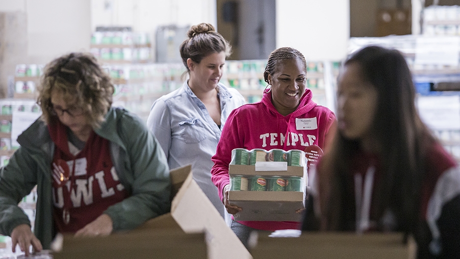 Volunteers working together to package food.  