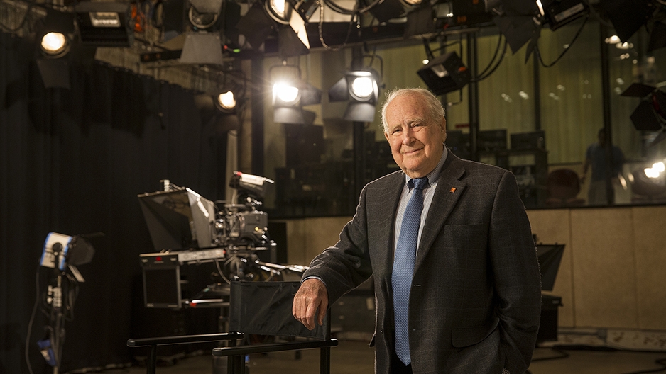 Lew Klein standing in a studio near a camera