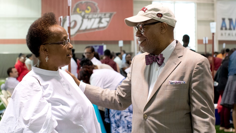 Michael Robinson talks with a woman at the Neighborhood Job Fair