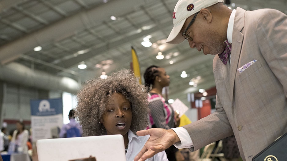 Two people talking at the job fair. 