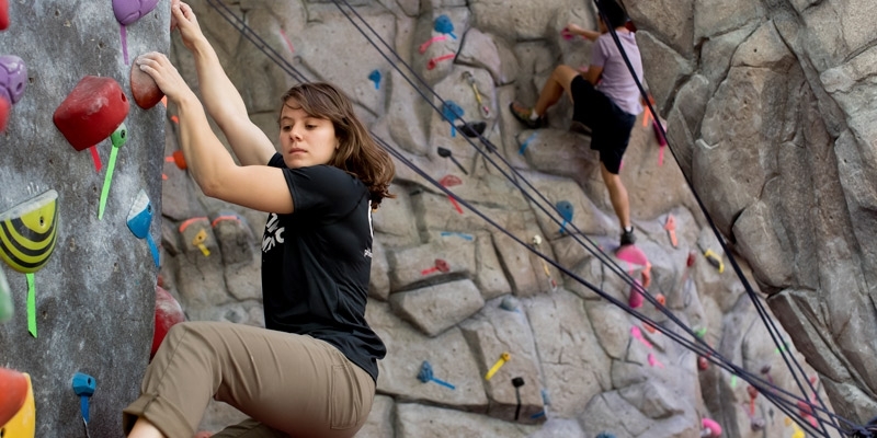 Zoe Steinberg climbing a rock wall