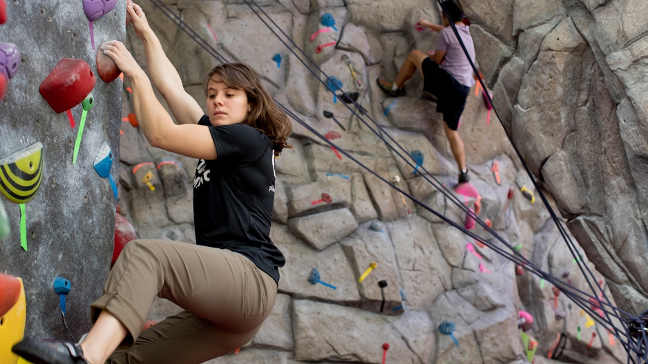 Zoe Steinberg climbing a rock wall