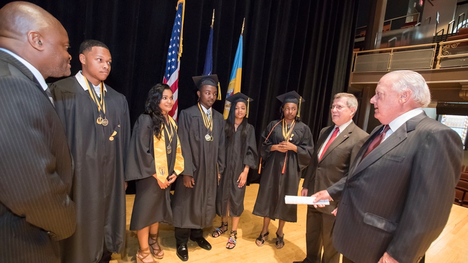 Graduating students and Temple leaders talking at Carver's graduation ceremony.