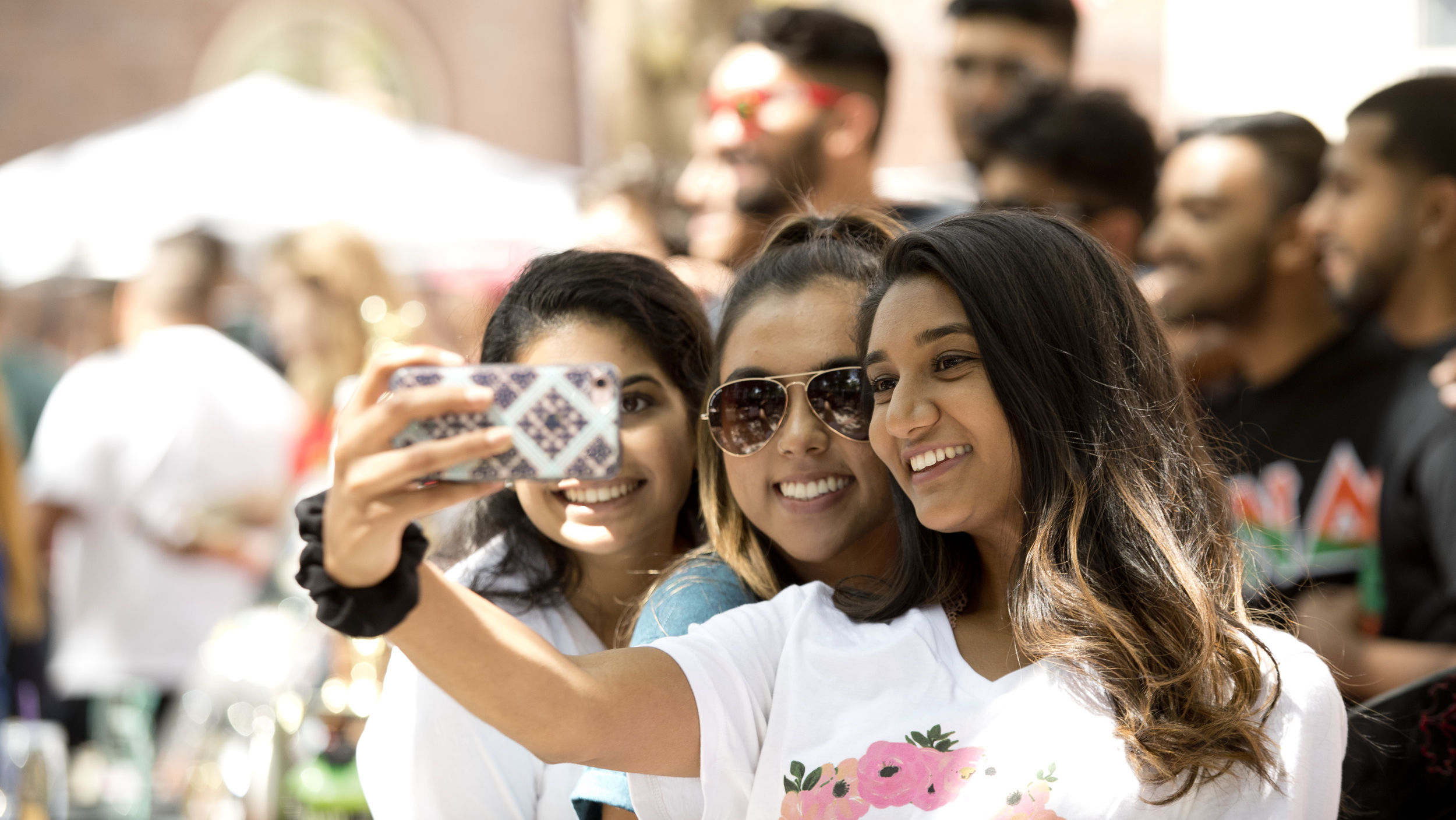 Students taking a selfie together outside