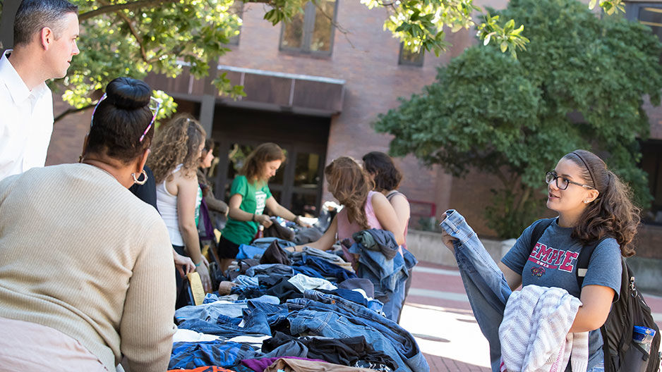 student perusing at Temple pop up thrift