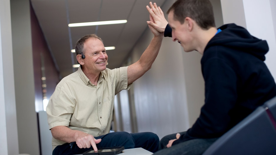 Professor John Nosek demonstrating GAINS on a tablet with a student