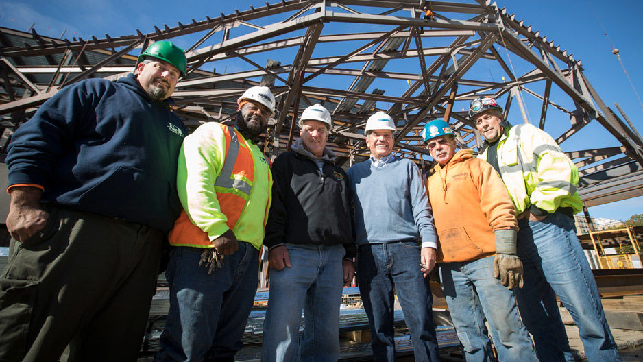 Construction workers standing together at the library site