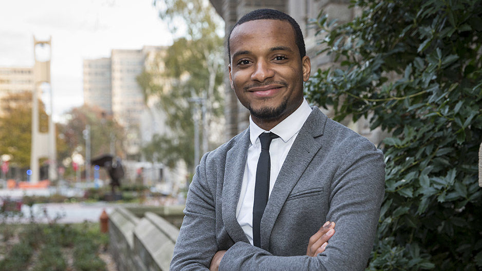 Hazim Hardeman standing on campus in front of the Bell Tower