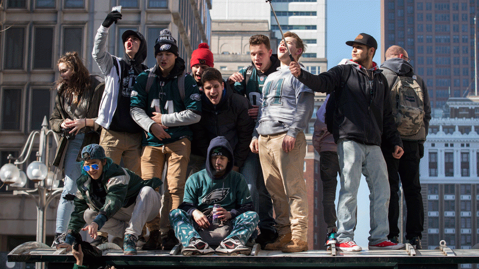 A group of people cheering during the Eagles Super Bowl celebration