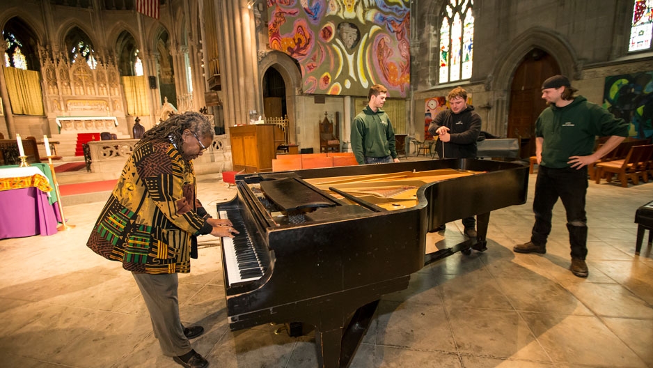 The Rev. Renee McKenzie plays a piano donated by Temple