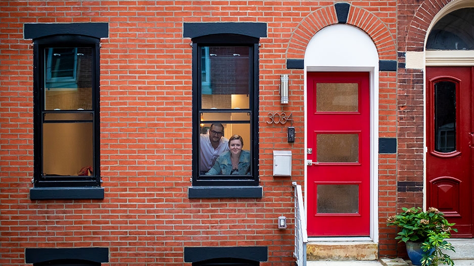 Allie Sokoloff and Tyler Kmiec looking out their front window