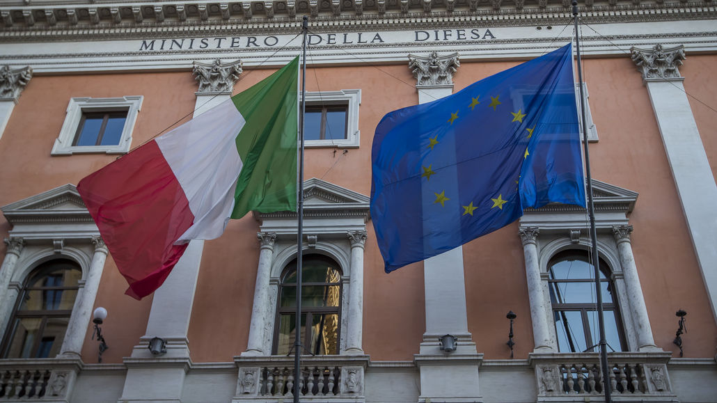 Image of the Italian and European flags on a building.