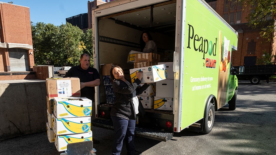 people unloading a Giant truck packed with donations