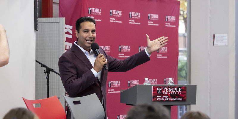 Image of Kevin Negandhi speaking at a summit event on Main Campus.