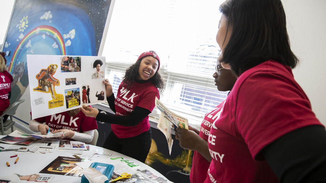  Image of women wearing cherry and white MLK Day shirts. 