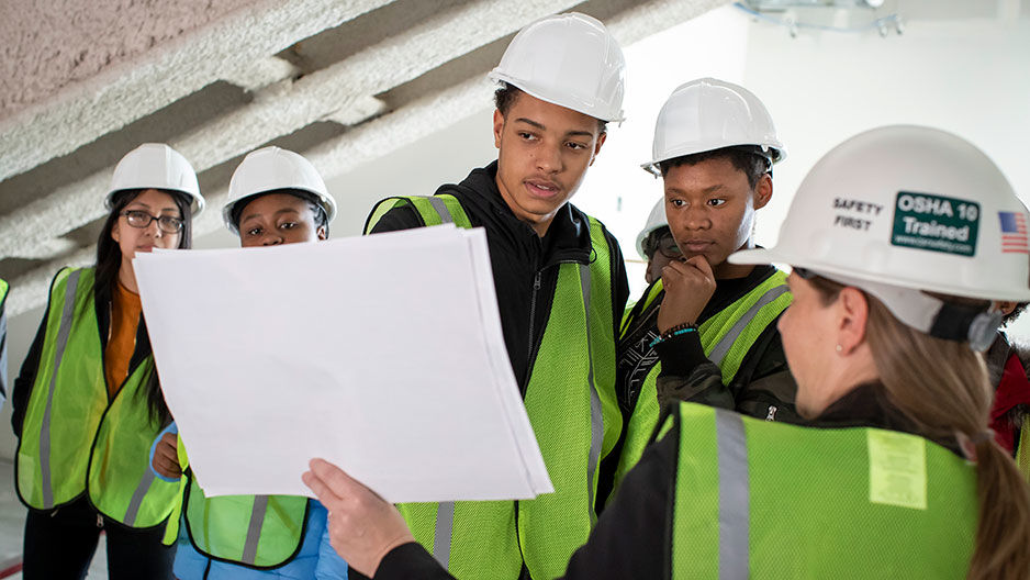 Students tour the Charles Library construction site