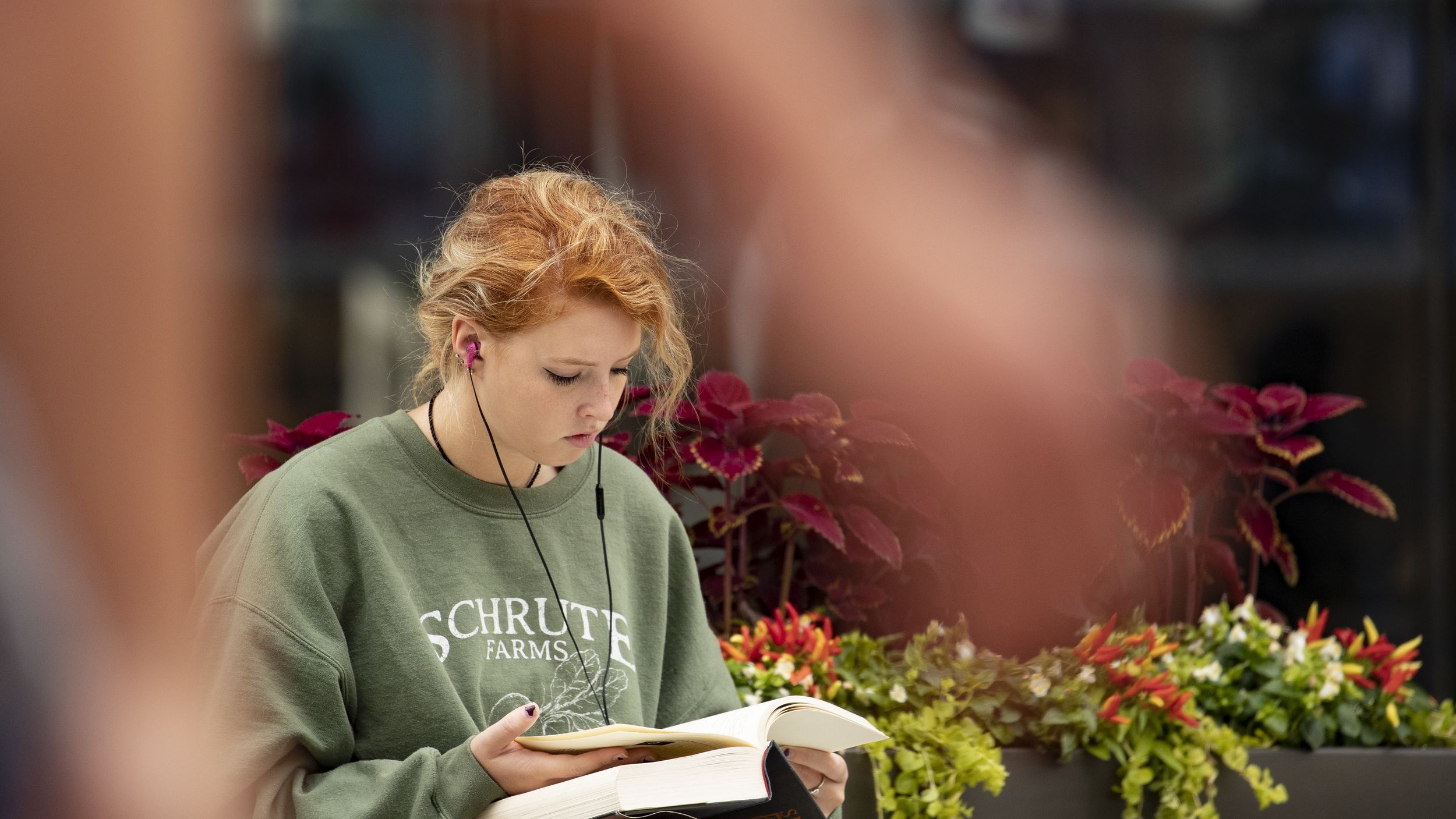 A student reading outside Charles Library