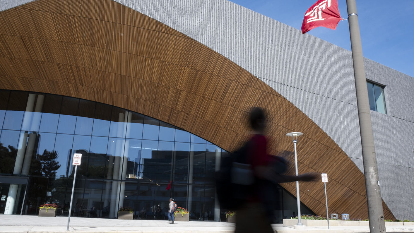 a student walks past Charles Library