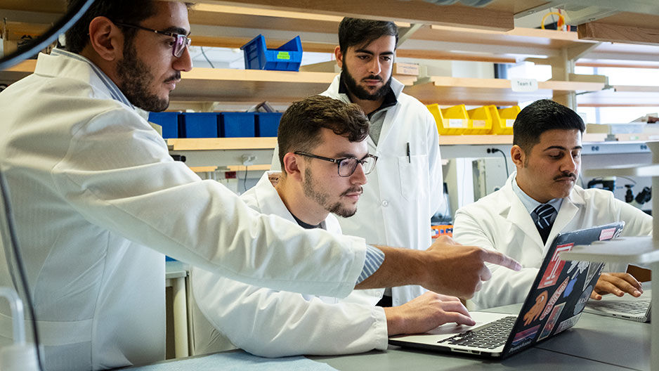 Bioengineering students working together on laptops in a lab