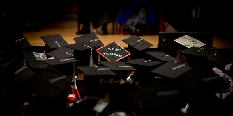 Image of Temple graduates in their graduation caps.