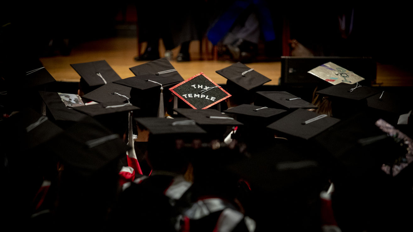 Image of Temple graduates in their graduation caps.