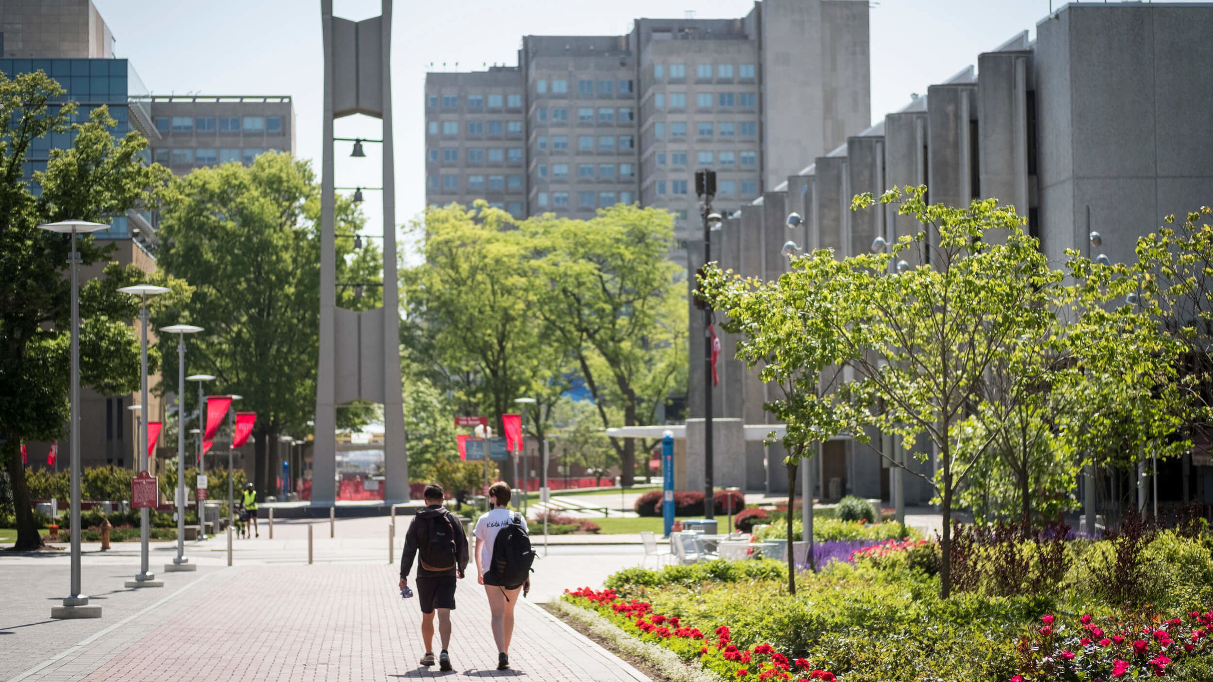 Students walk towards the Bell Tower on Main Campus.