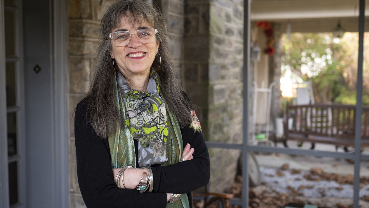 Author and Temple Professor Laura Levitt stands on the front porch of her home.