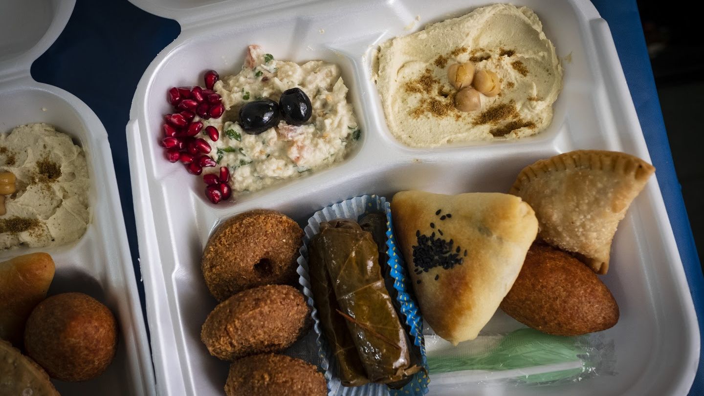 Image of Takeout containers of Syrian delicacies were distributed to guests of a virtual dinner.