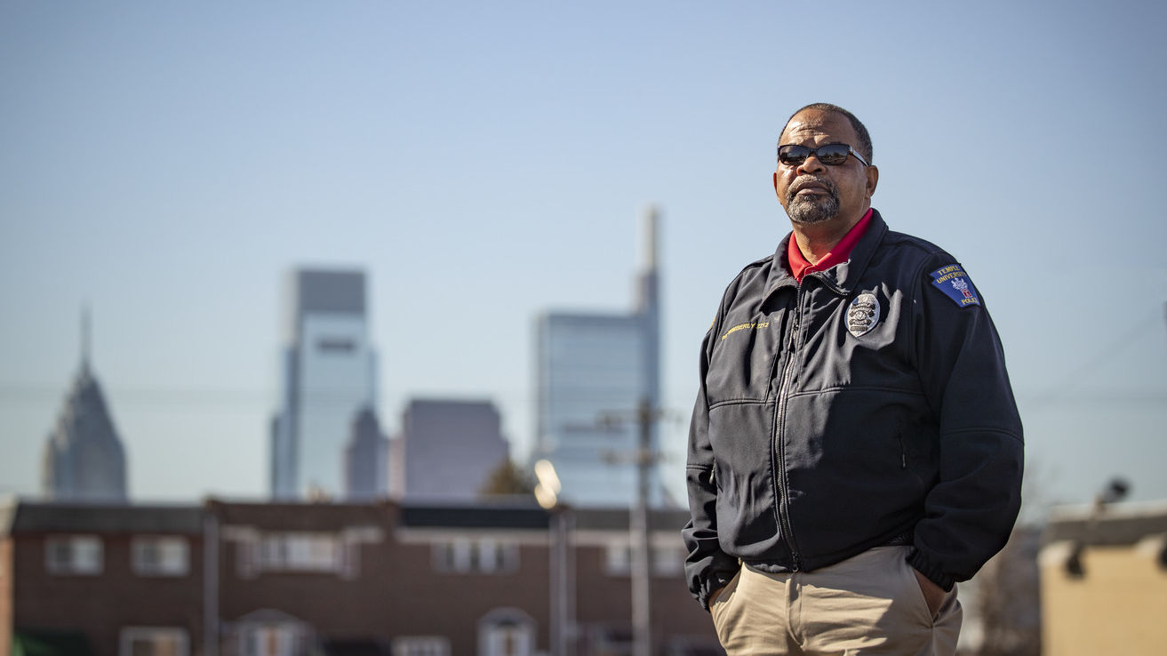 Image of a man in a Temple Police officer jacket outside in North Philadelphia. 