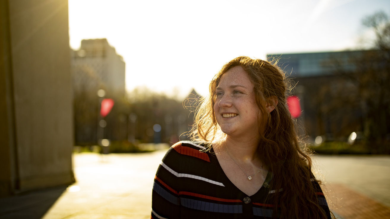 Natalie Ross standing before a sunset.