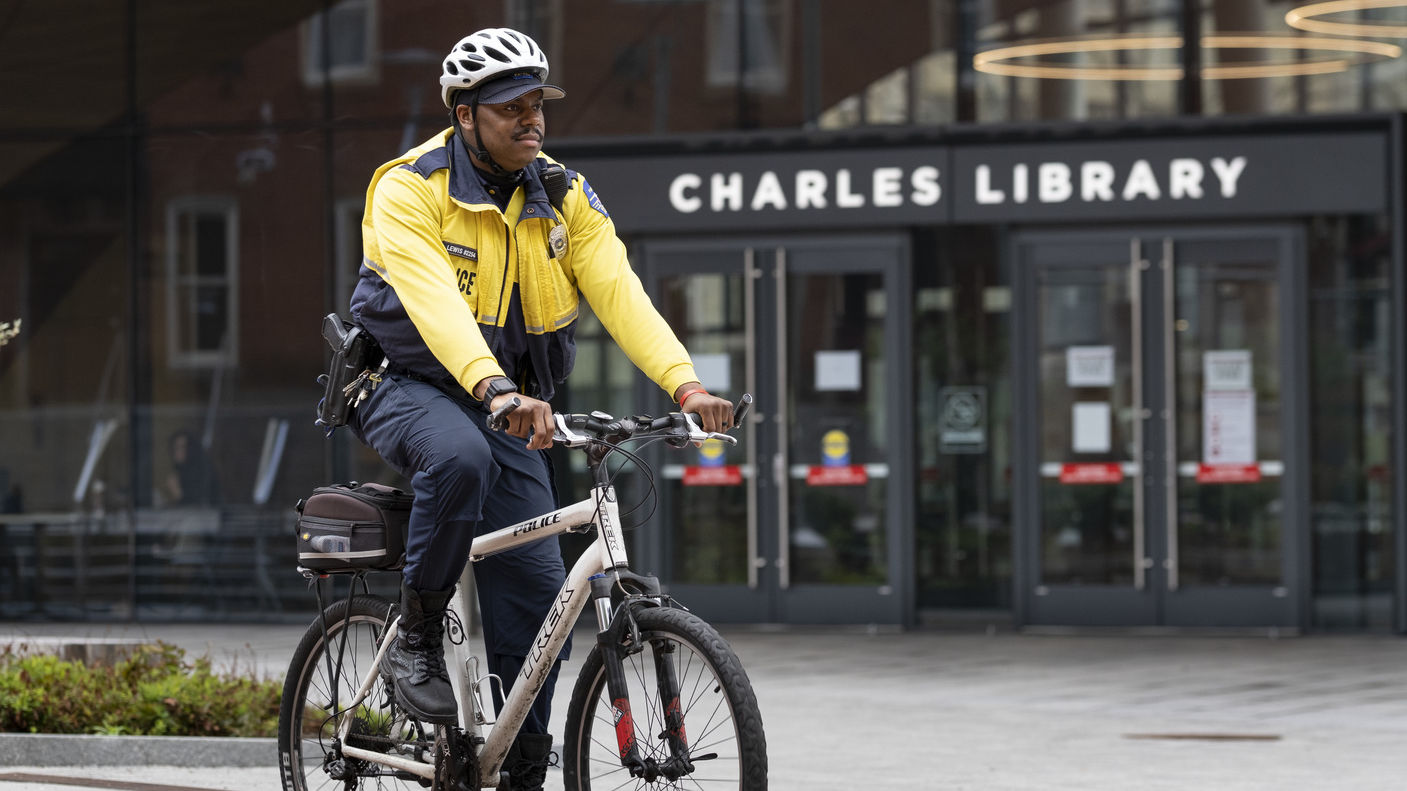 Officer Eliajah Lewis pictured on a bike outside Charles Library.
