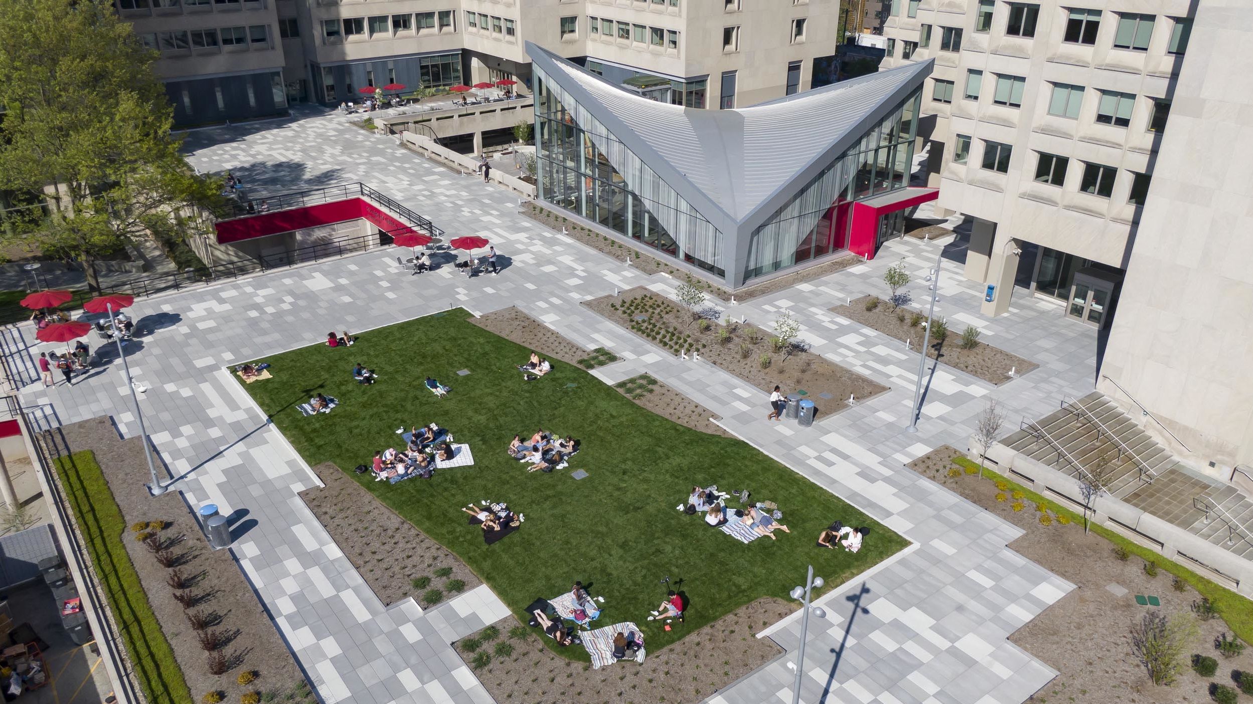 students lounging on the green space atop Anderson Hall