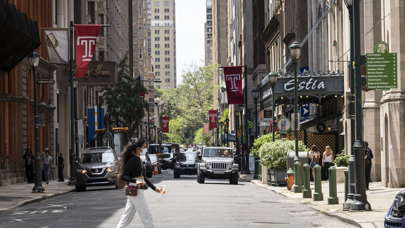 A young woman crosses the street in Center City.