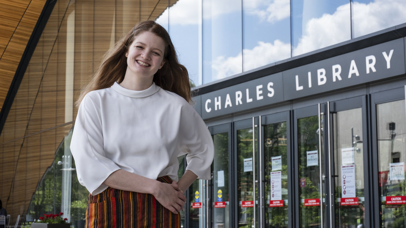 Kirtney Metz standing in front of Charles Library