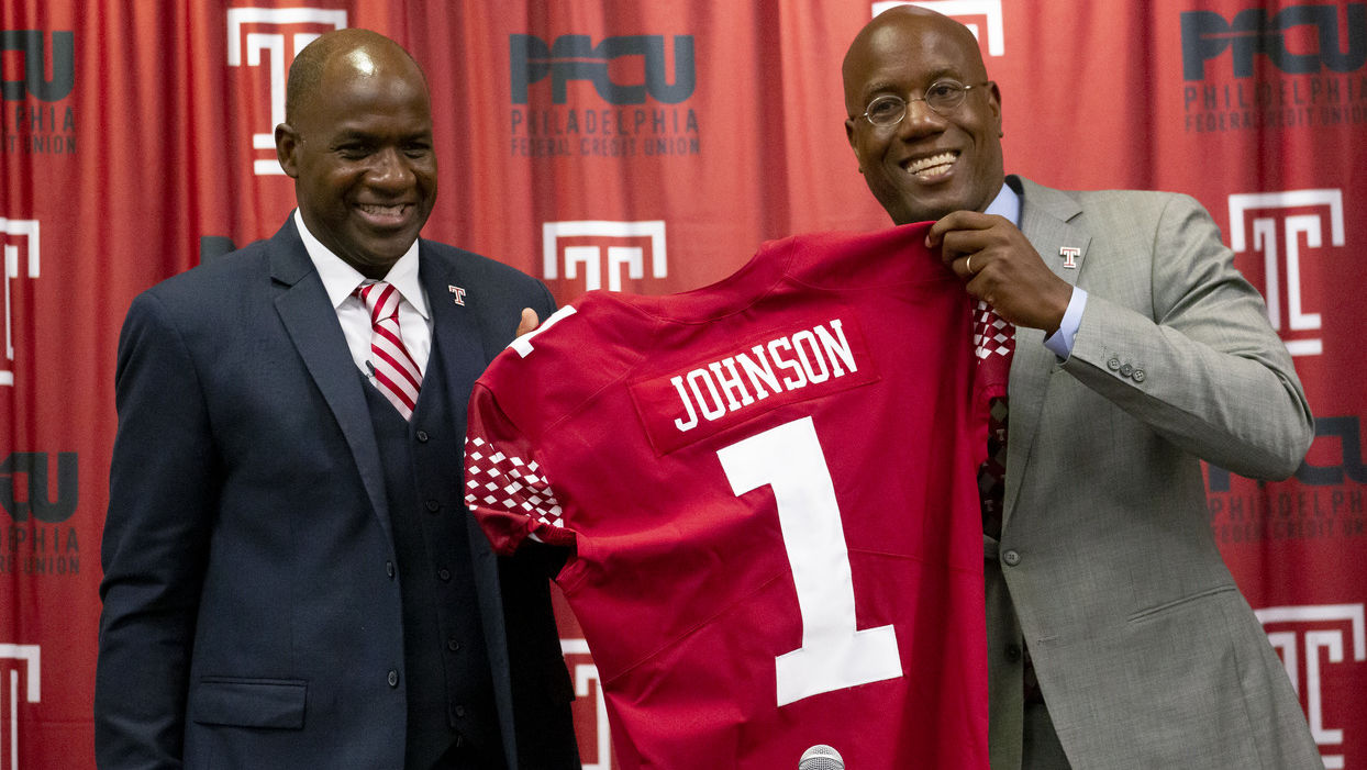 Arthur Johnson pictured with President Wingard, holding Johnson's replica Temple jersey.