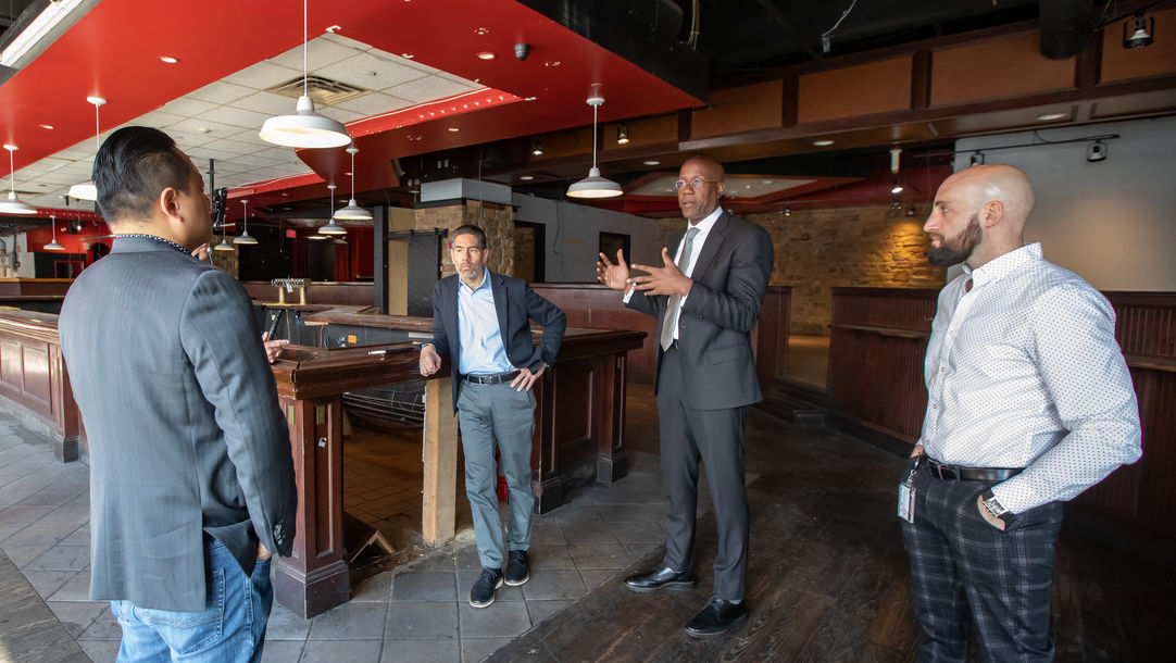 Image of President Jason Wingard and others standing indoors.