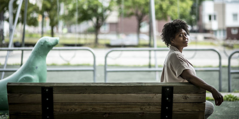 Monica Hankins-Padilla poses on a park bench in the North Philadelphia community she serves.