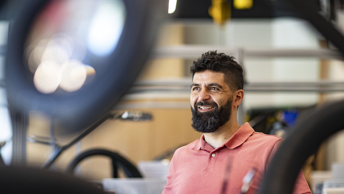 Image of Iyad Obeid sitting in an engineering lab.