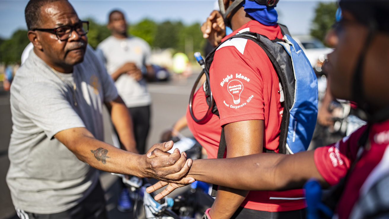 Police officer and student shake hands