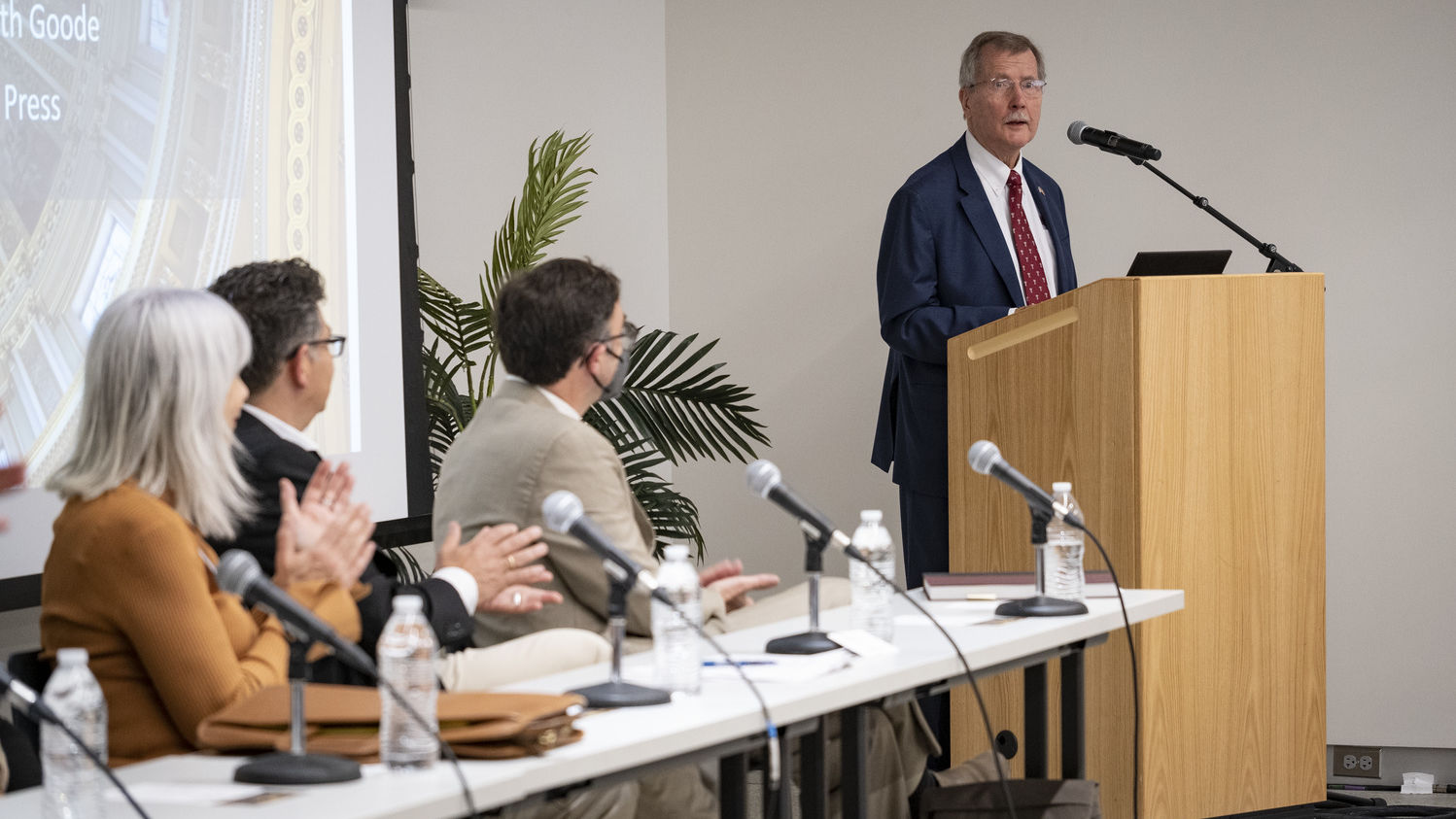 Richard Englert at a podium speaking during a Temple Press event.