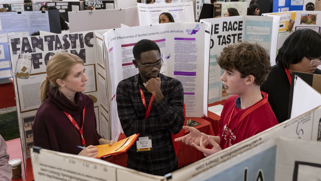 Judges and a student at the science fair