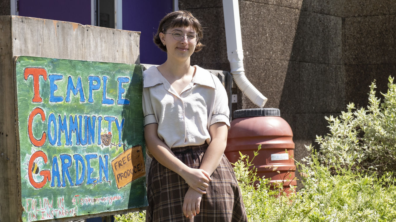 Hamilton poses near the Temple Community Garden sign