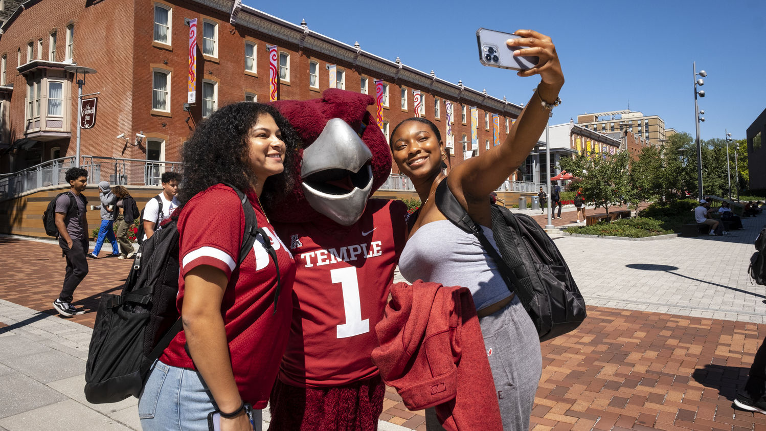 A photo of students taking a photo with Hooter.