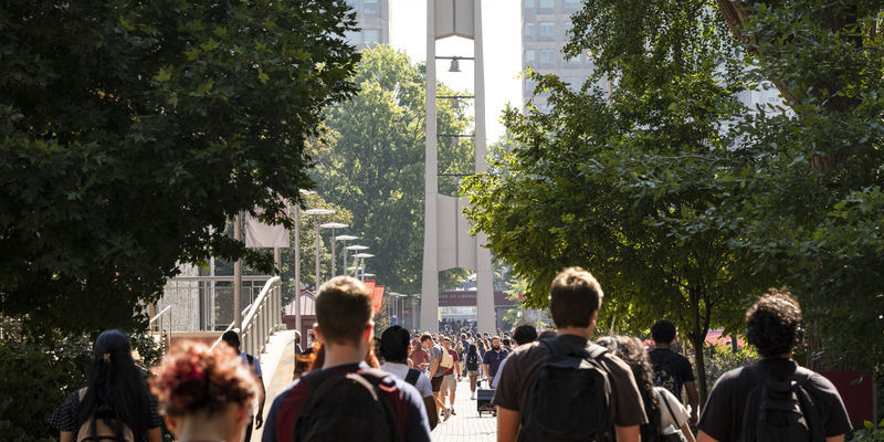Temple students walk to class in front of the campus’ iconic Bell Tower.