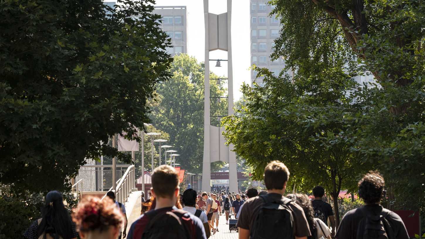 Temple students walk to class in front of the campus’ iconic Bell Tower.