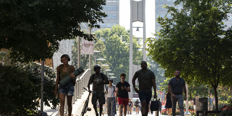 Students walking with Bell Tower in the background