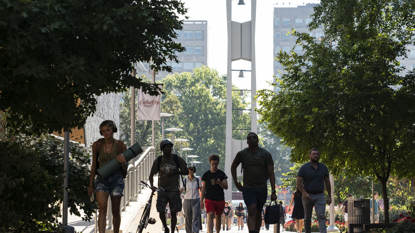 Students walking with the Bell Tower in the background