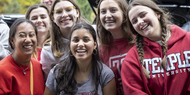 Temple students wearing Temple logo gear.