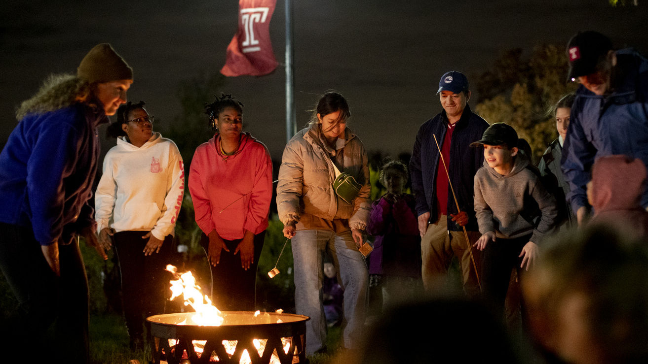 Attendees roasting marshmallows.